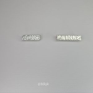 Timberland Stainless Steel Shoelace Charms "LOVE STINKS"